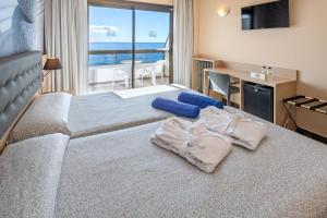 a hotel room with two beds with a view of the ocean at Tropic Park in Malgrat de Mar