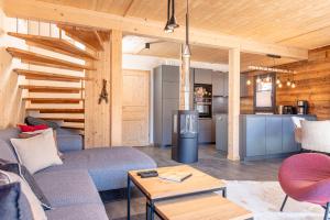 a living room with a couch and a table at Bergeralm Chalets by ALPS RESORTS in Steinach am Brenner +30 photos