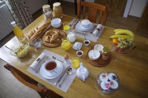einen Tisch mit Frühstückszutaten und Getränken darauf in der Unterkunft Chambres & Table d'hôtes de La Vieille Ferme in Salon-la-Tour