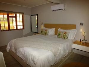 a bedroom with a large bed with white sheets and pillows at Lauradale Accommodation in Stellenbosch