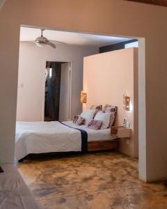 a bedroom with a large bed with a large mirror at Nativ Lodge and Spa in Mahébourg