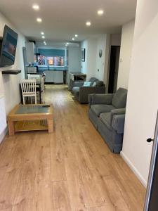 a living room with a couch and a table at Corporate Large Modern 4 to 5 Bedroom House in Bishops Stortford