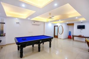 a pool table in a room with a ceiling at FabExpress Taj Home Stay in New Delhi