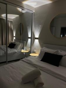 a bedroom with a large bed and a mirror at Liz suite in Caesarea
