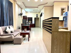 a living room with a couch and a table at T's House Motel in Ấp Bình Hưng