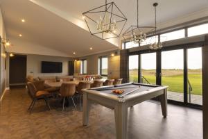 a dining room with a billiard table and a bar at Dundonald Links in Dreghorn