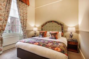 a bedroom with a large bed and a window at The Wynnstay Hotel, Oswestry, Shropshire in Oswestry