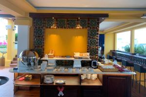 a kitchen with a counter with dishes on it at Duc Vuong Saigon Hotel - Bui Vien in Ho Chi Minh City