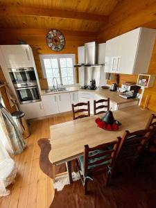 a kitchen with a wooden table in a room at Chalet de Notre Dame in Le Tampon +10 photos