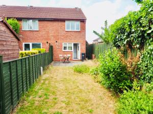 a house with a fence and a yard at Free Parking 2 Bed With Garden, Fibre Wi-Fi & Netflix in Taunton