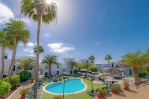 an aerial view of a resort with a pool and palm trees at Nazaret Sol in Costa Teguise