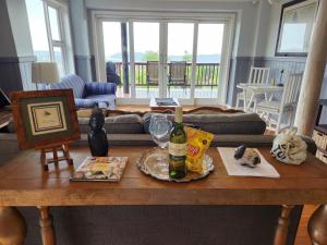 a living room with a table with a bottle of wine at Knysna River View in Knysna