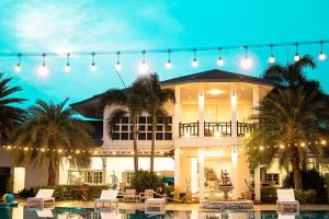 a large house with a pool in front of it at ทรายทอง รีสอร์ท in Ban Pru Yai