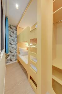 a small room with a bed and a closet at Bastille ChicSuites in Paris