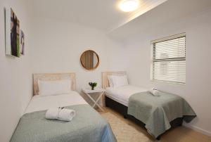 Postel nebo postele na pokoji v ubytování Designer Beachfront Apartment in Big Bay with swimming pool- 2 bedroom, 1 Azure