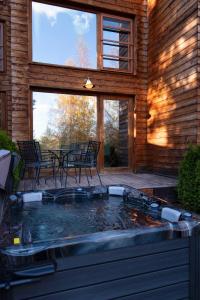 a hot tub in the backyard of a house at PinusVillas Conference Lodge in Zheleznitsa