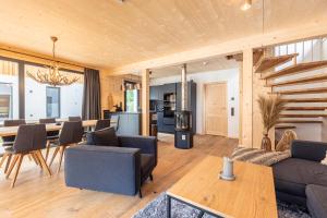 a living room with a couch and a table at Alpenchalets Biberwier Zugspitze by ALPS RESORTS in Biberwier
