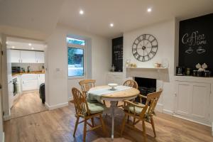 a kitchen and dining room with a table and chairs at Stylish and Modern Town Centre End-of Terrace Home in Newton Abbot +12 photos