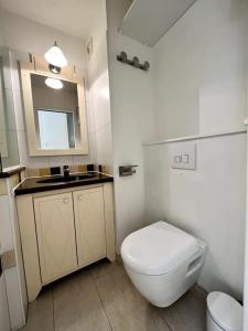 y baño con aseo blanco y lavamanos. en Casa Alessia - Villefranche-sur-mer en Villefranche-sur-Mer