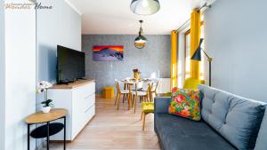 salon z kanapą i stołem w obiekcie Wonder Home - Apartamenty położone blisko deptaka, licznych restauracji i sklepów w mieście Karpacz