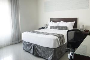 Uma cama ou camas num quarto em Hotel Latitud 15