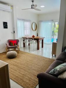 a living room with a couch and a table at Holiday house near Lamai with swimming pool. 2 bedrooms in Amphoe Koksamui