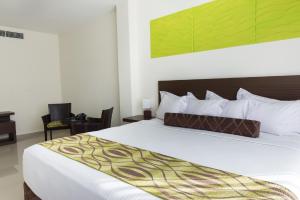 Uma cama ou camas num quarto em Hotel Latitud 15