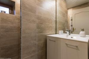 un bagno con lavandino e doccia di Gîte Sylvie a Planchez