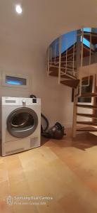 a room with a washing machine and a bunk bed at Ker Karantez in Rennes