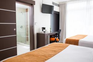 Uma cama ou camas num quarto em Hotel Latitud 15