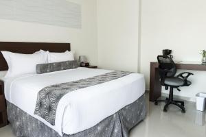 Uma cama ou camas num quarto em Hotel Latitud 15