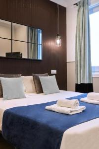 a bedroom with two beds with towels on them at Jorge Juan Excellent, by Presidence Rentals in Madrid