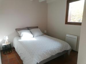 a bedroom with a white bed and a window at T1 Proche Annecy in Épagny