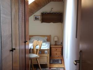a small bedroom with a bed and a chair at Vermietung Gisl in Wiesent