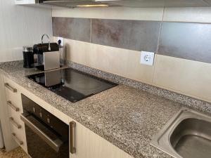 a kitchen with a sink and a counter top at Calpe Mar y Playa in Ifach