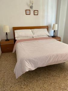 a bedroom with a large bed with two night stands at Calpe Mar y Playa in Calpe