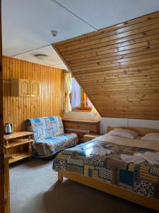 a bedroom with two beds and a couch in a room at Villa Ibar in Borovets