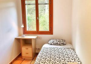 a small room with a bed and a window at Casa Donaire in Marganell +22 photos