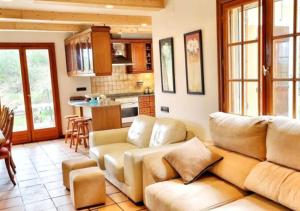 a living room with a couch and a kitchen at Casa Donaire, alojamiento turístico in Marganell