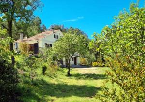 a house in the middle of a field with trees at Casa Donaire, alojamiento turístico in Marganell