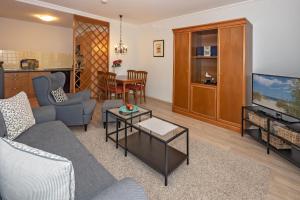 a living room with a couch and a tv at Seehof Seehof 102 in Bansin