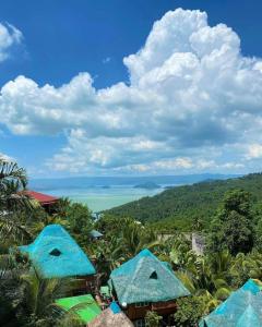 a view of the ocean from a resort with blue roofs at La Virginia Leisure Park and Amusement powered by Cocotel in Mataasnakahoy