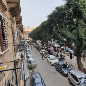 a busy city street with cars parked on the sidewalk at essential in Palermo