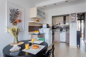 a kitchen with a black table with food on it at Floral Apartment - NEW in town in Budapest