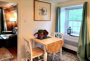 a room with a table and chairs and a dining room at Victorian Apt at SanctuaryoftheSwan dog friendlyhotel alternative farm stay in Birdsboro