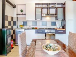 eine Küche mit einem Tisch mit einer Schüssel Essen drauf in der Unterkunft Apartments Žaknić in Prizba