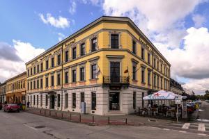 a yellow and white building on the corner of a street at Aparthotel Iosefin Residence in Timişoara