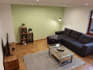 a living room with a couch and a coffee table at Familienfreundliche FeWo in Offenburg