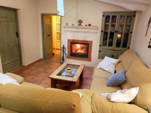 a living room with a couch and a fireplace at Cortijo Aldamuz-VTAR102 in Oria