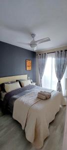 a bedroom with a large bed with a ceiling fan at Hernando Sea Front Optic Fiber Internet Apartment in Calpe